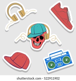 Five stickers hip-hop on the grey background: headphones, hat, sneakers, Boombox, skull. Vector image. Street style. Shadow.