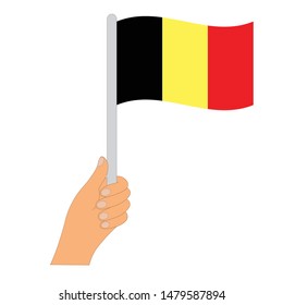 Flag of Belgian  . Hand holding a Belgian flag - vector icon.