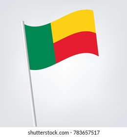 Flag of Benin , Benin flag waving isolated vector illustration,vector waving simple triangle African flag on pole - national symbol of Benin with inclined metal stick.