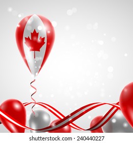 Flag of Canada on balloon. Celebration and gifts. Ribbon in the colors are twisted. Balloons on the feast of the national day. 