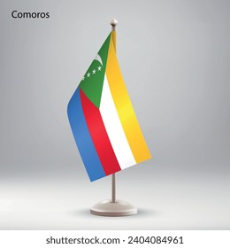 Bandera de las Comoras colgando de un puesto de bandera. Utilizable para la presentación en la cumbre o en la conferencia