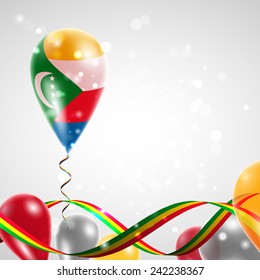 Flag of Comoros on balloon. Celebration and gifts. Ribbon in the colors are twisted. Balloons on the feast of the national day. 
