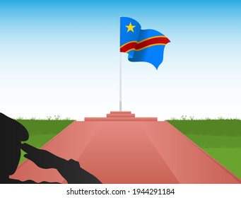 The Flag Of The Democratic Republic Of Congo Sits On A Pole With The Image Of A Soldier Saluting The Flag