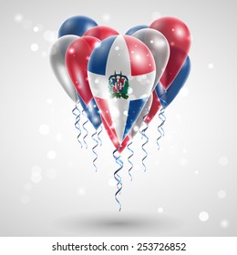 Flag of Dominican Republic on air balls in heart-shaped. Celebration and gifts. Ribbon in the colors are twisted under the balloon. Independence Day. Balloons on feast of the national