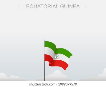 The flag of Equatorial Guinea flying on a pole standing tall against a white sky