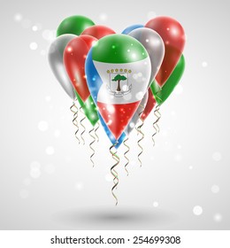 Flag of Equatorial Guinea on air balls in heart-shaped. Celebration and gifts. Ribbon in the colors are twisted under the balloon. Independence Day. Balloons on feast of the national 