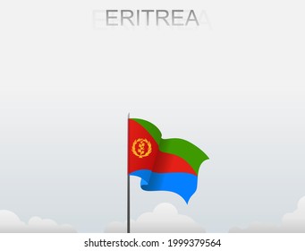 The flag of Eritrea flying on a pole standing tall under the white sky