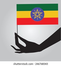 Flag of Ethiopia in a female hand. Vector illustration.