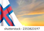 Flag of the Faroe Islands against the sunset. Patrioric background. EPS10 vector