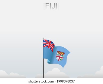 The flag of Fiji flutters on a pole standing tall under a white sky