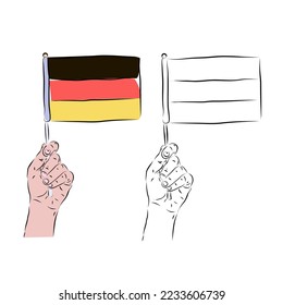 The flag of Germany in the hand of a man in color and black and white background. The concept of German patriotism.