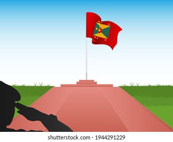 The flag of Grenada flies above the pole in the shadow of a soldier saluting the flag