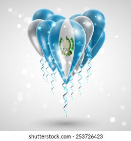 Flag of Guatemala on air balls in heart-shaped. Celebration and gifts. Ribbon in the colors are twisted under the balloon. Independence Day. Balloons on the feast of the national