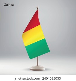 Bandera de Guinea colgando en un puesto de bandera. Utilizable para la presentación en la cumbre o en la conferencia
