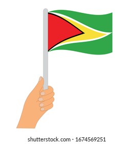Flag of Guyana . Hand holding a Guyana 
 flag - vector icon.