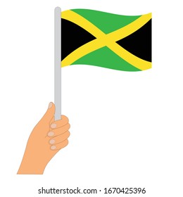 Bandera de Jamaica . Mano sosteniendo una Jamaica  
 , icono vectorial.