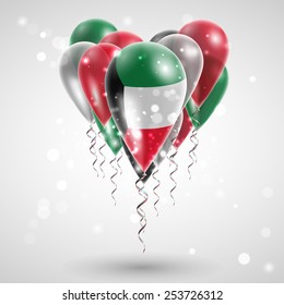 Flag of Kuwait on air balls in heart-shaped. Celebration and gifts. Ribbon in the colors are twisted under the balloon. Independence Day. Balloons on the feast of the national