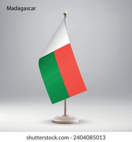 Flag of Madagascar hanging on a flag stand. Usable for summit or conference presentaiton