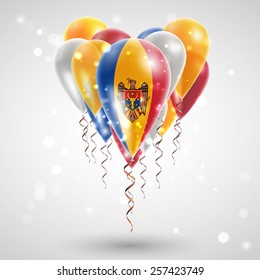 The flag of Moldova on air balls in heart-shaped. Celebration and gifts. Ribbon in the colors are twisted under the balloon. Independence Day. Balloons on feast of the national