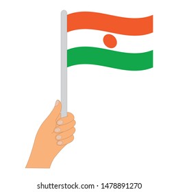 Flag of Niger  . Hand holding a Niger  flag - vector icon.