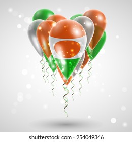 Flag of Niger on air balls in heart-shaped. Celebration and gifts. Ribbon in the colors are twisted under the balloon. Independence Day. Balloons on the feast of the national
