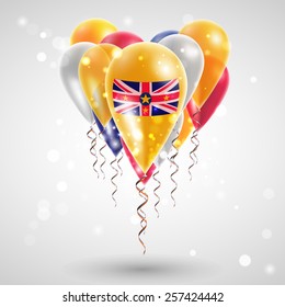 Flag of Niue on air balls in heart-shaped. Celebration and gifts. Ribbon in the colors are twisted under the balloon. Independence Day. Balloons on feast of the national