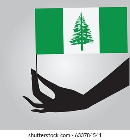 Flag of Norfolk Island in a female hand. Vector illustration.