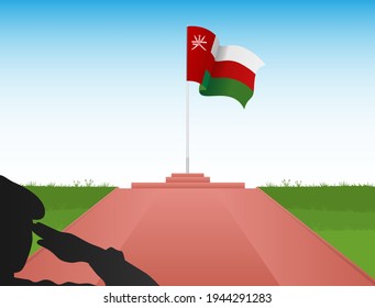 The flag of Oman flies above the pole in the image of a soldier saluting the flag