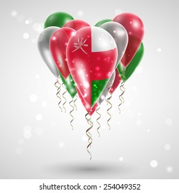 Flag of Oman on air balls in heart-shaped. Celebration and gifts. Ribbon in the colors are twisted under the balloon. Independence Day. Balloons on the feast of the national