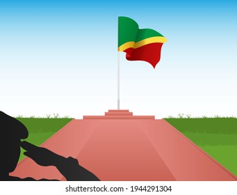 The Flag Of The Republic Of Congo Flies Above The Pole In The Shadow Of A Soldier Saluting The Flag