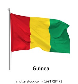 Flag of the Republic of Guinea in the wind on flagpole, vector