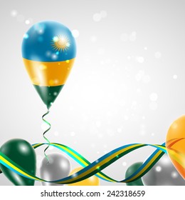 Flag of Rwanda on balloon. Celebration and gifts. Ribbon in the colors are twisted. Balloons on the feast of the national day. 