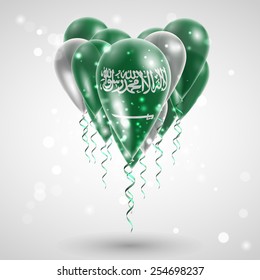 Flag of Saudi Arabia on air balls in heart-shaped. Celebration and gifts. Ribbon in the colors are twisted under the balloon. Independence Day. Balloons on the feast of the national