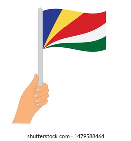 Flag of Seychelles . Hand holding a Seychelles flag - vector icon.