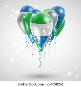 Flag of Sierra Leone on air balls in heart-shaped. Celebration and gifts. Ribbon in the colors are twisted under the balloon. Independence Day. Balloons on the feast of the national