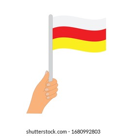 Flag of South ossetia . Hand holding a South ossetia flag - vector icon.