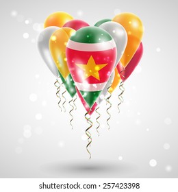 Flag of Suriname on air balls in heart-shaped. Celebration and gifts. Ribbon in the colors are twisted under the balloon. Independence Day. Balloons on feast of the national