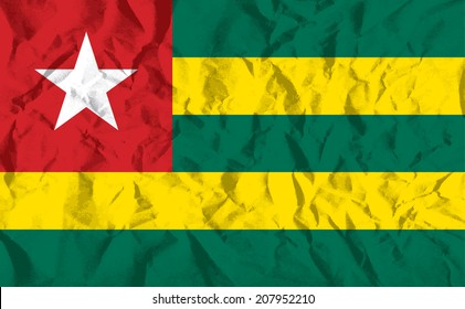 Flag of Togo on wrinkled paper vector illustration.