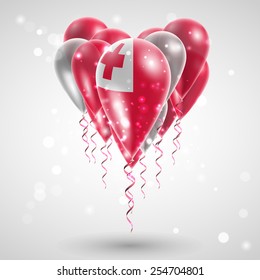 Flag of Tonga on air balls in heart-shaped. Celebration and gifts. Ribbon in the colors  are twisted under the balloon. Independence Day. Balloons on the feast of the national
