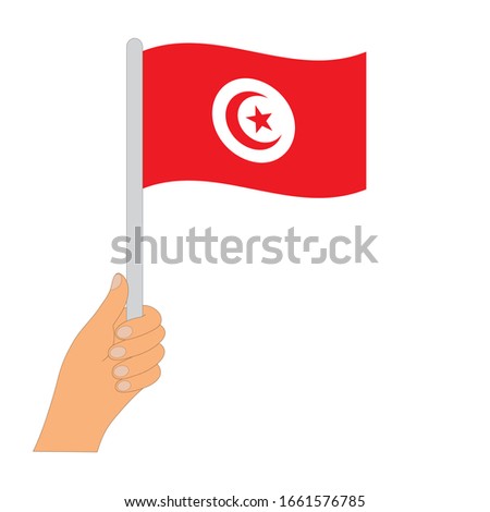 Flag of Tunisia   . Hand holding a Tunisia   flag - vector icon.