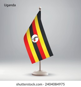 Bandera de Uganda colgando en un puesto de bandera. Utilizable para la presentación en la cumbre o en la conferencia
