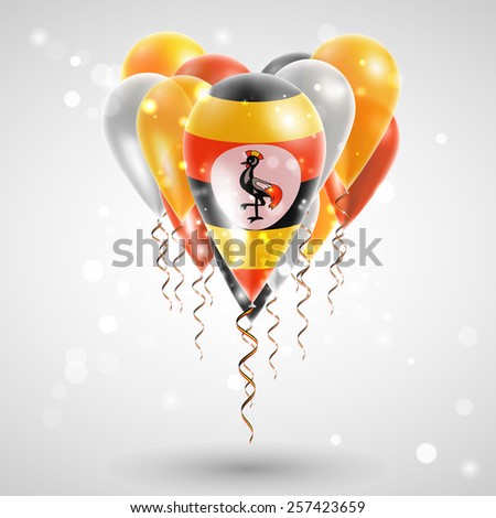Flag of Uganda on air balls in heart-shaped. Celebration and gifts. Ribbon in the colors are twisted under the balloon. Independence Day. Balloons on feast of the national