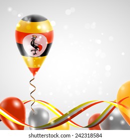 Flag of Uganda on balloon. Celebration and gifts. Ribbon in the colors are twisted. Balloons on the feast of the national day. 