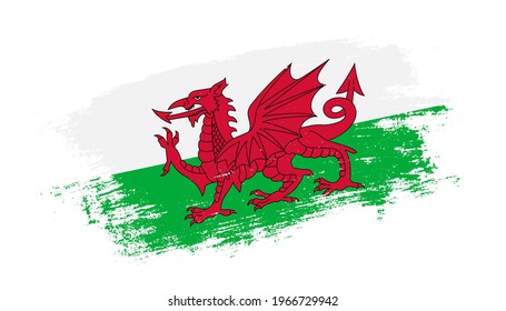 Flag of Wales country on brush paint stroke trail view. Elegant texture of national country flag
