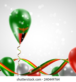 Flag of Zambia on balloon. Celebration and gifts. Ribbon in the colors are twisted. Balloons on the feast of the national day. 