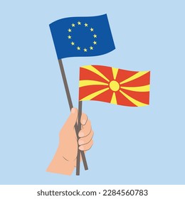 Flags of EU and North Macedonia, Hand Holding flags