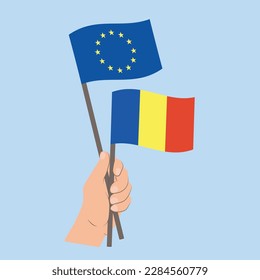 Banderas de la UE y Rumania, portadoras de la mano