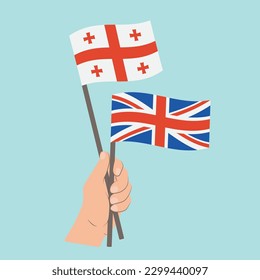 Flags of Georgia and UK, Hand Holding flags