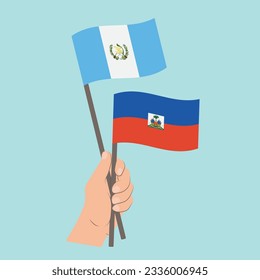 Banderas de Guatemala y Haití, mano con banderas