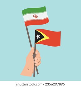 Banderas de Irán y Timor Oriental, mano con banderas